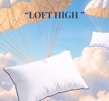 Labham Loft Pillow floating under a quilted parachute in a blue sky, white micro peach pillow with navy piping